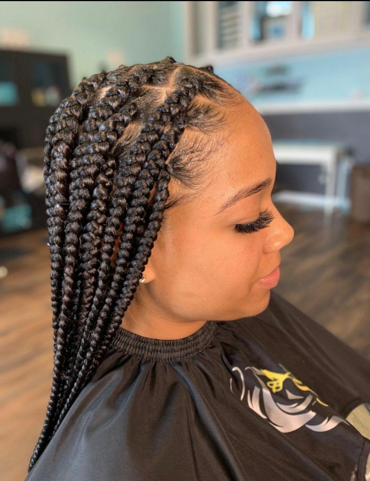 Fresh jumbo knotless box braids side profile in the salon chair with laid edges