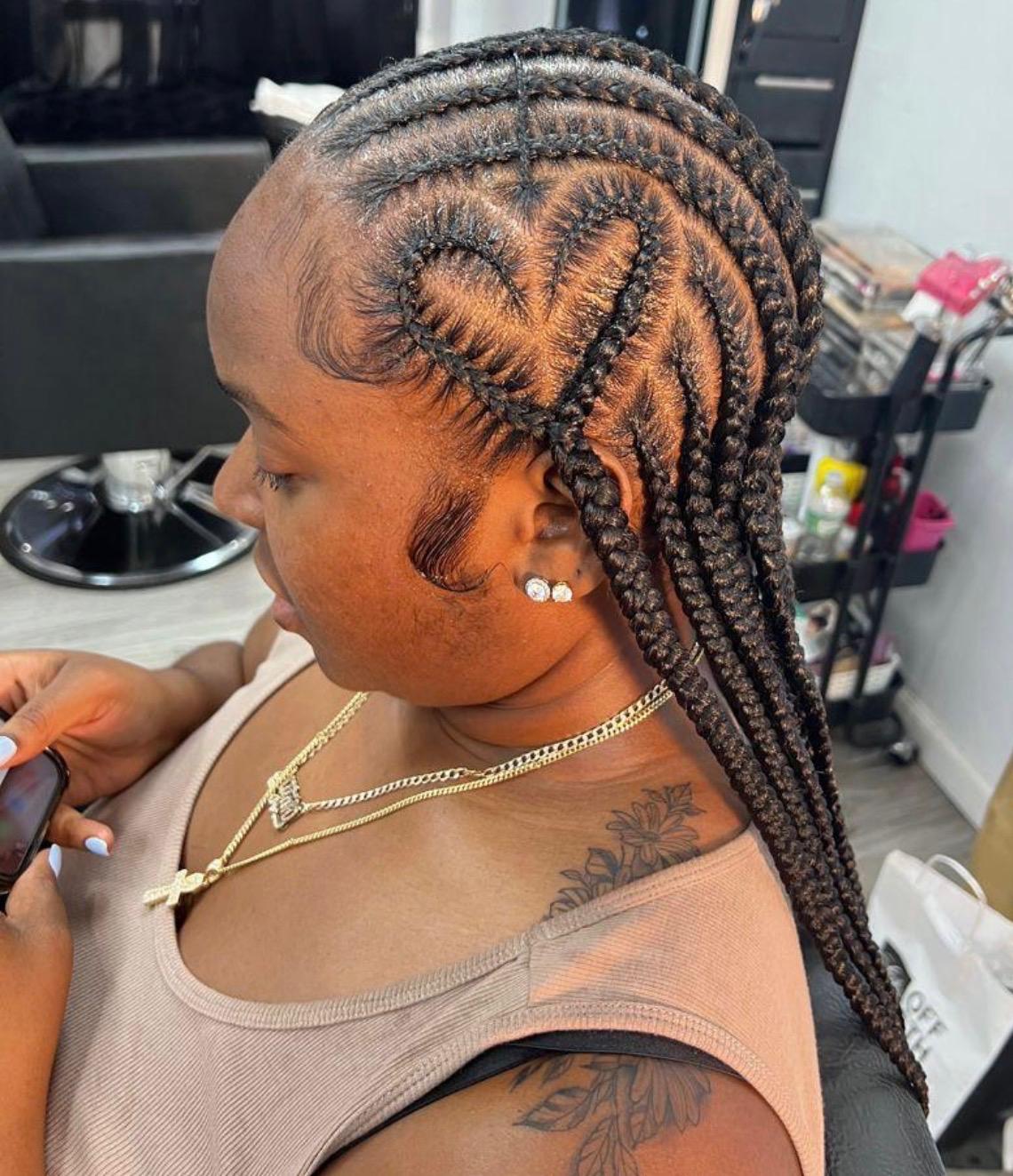 Side profile of a curved feed-in cornrow set with laid baby hairs in the Dayton salon chair