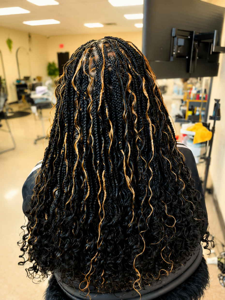 Boho knotless braids with honey blonde highlights and curly wavy ends installed at Sophia Hair Braiding Dayton