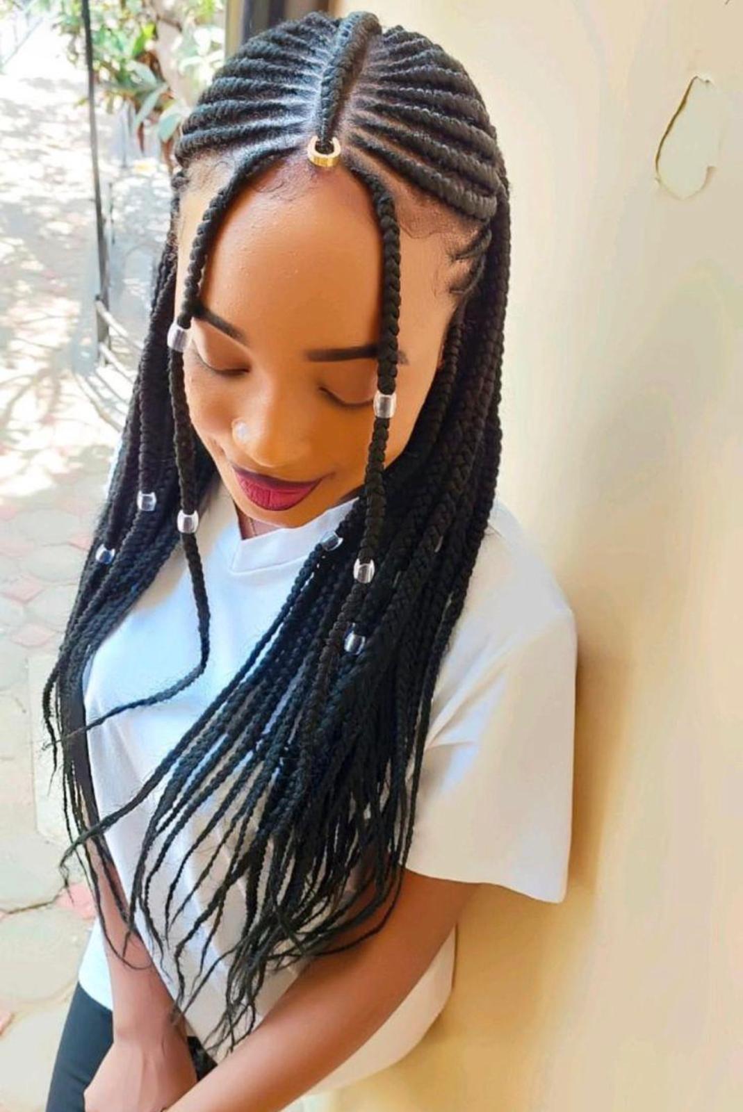 Top-down view of fulani-style feed-in cornrows with jumbo box braids and silver beaded accents