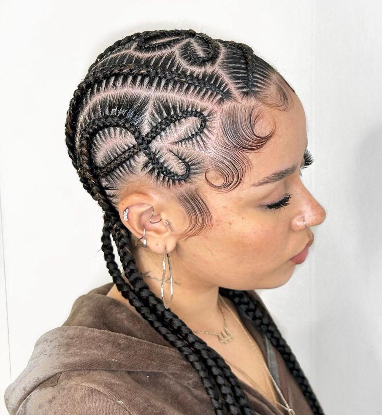 Artistic patterned cornrows with heart and loop designs paired with finger waves at the temples