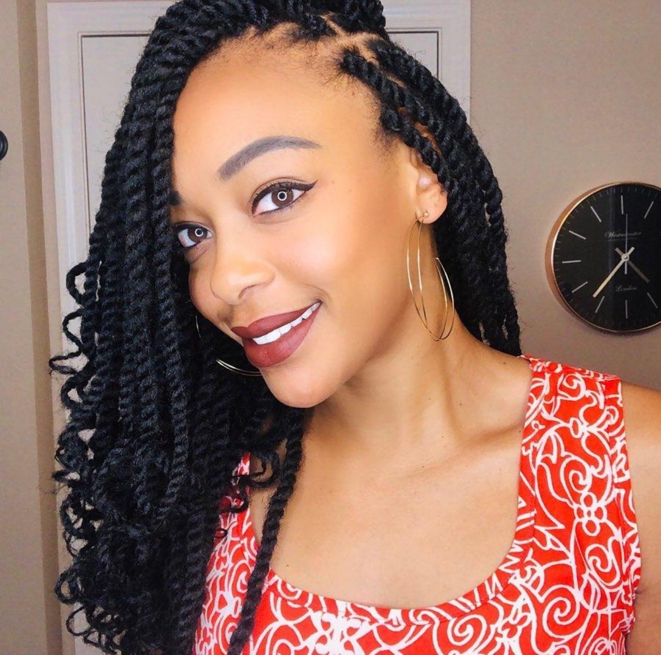 Shoulder-length marley twists with soft curly ends and gold hoop earrings