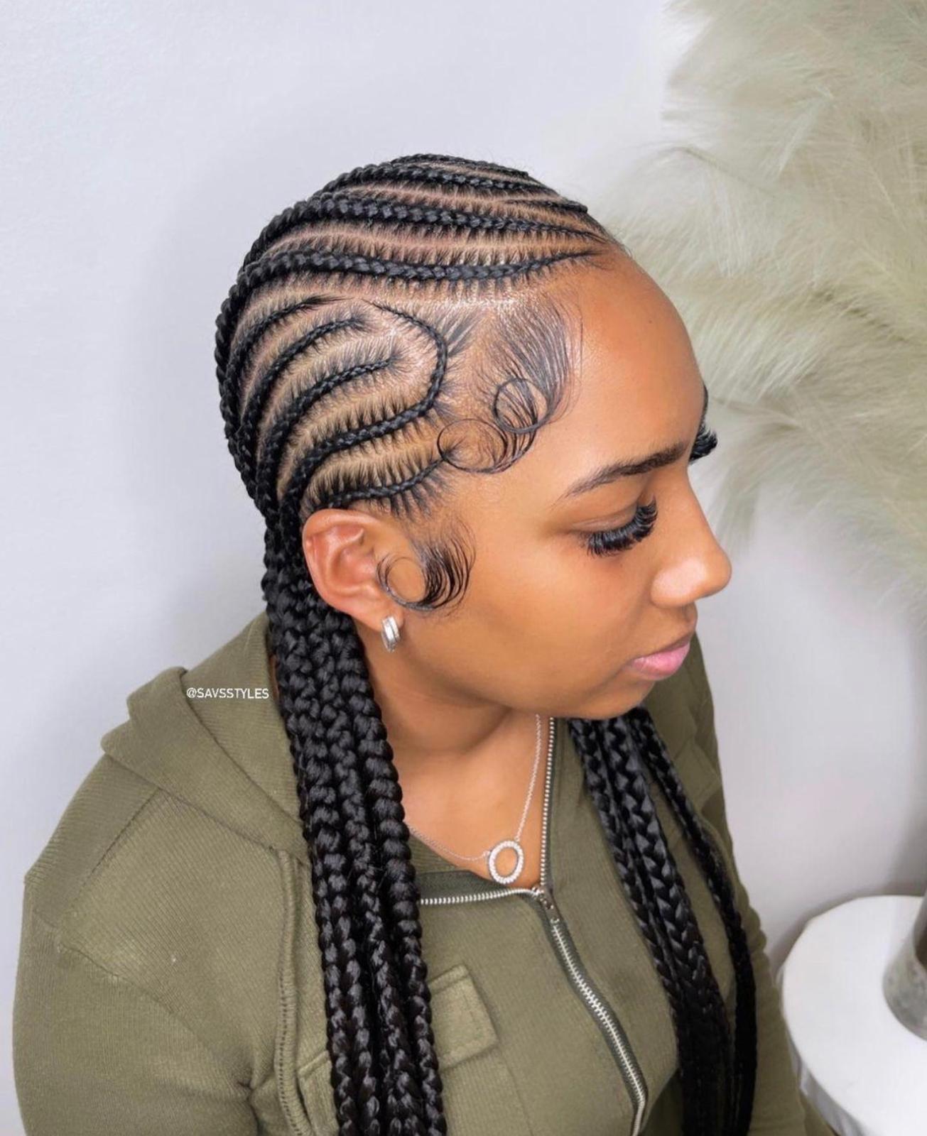 Sleek stitch feed-in cornrows with an intricate swirl design at the temple and laid edges