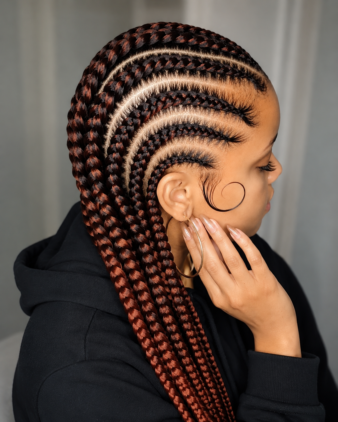 Sleek feed-in cornrows with copper highlights side profile Dayton Ohio